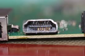 Macro view of a damaged HDMI port attached to the internal motherboard